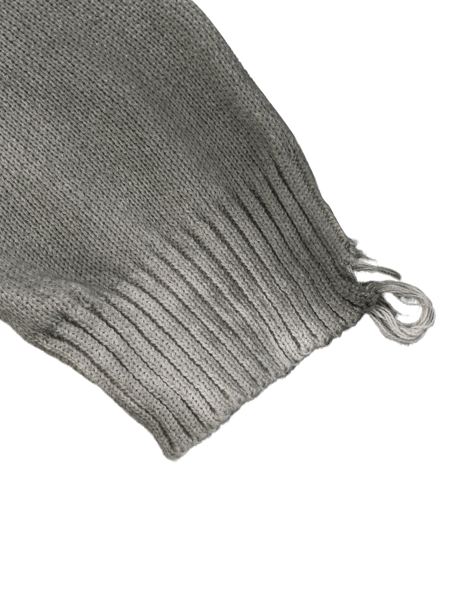 Ribbed knit sleeve cuff on light gray sweater with frayed edge and tie strings